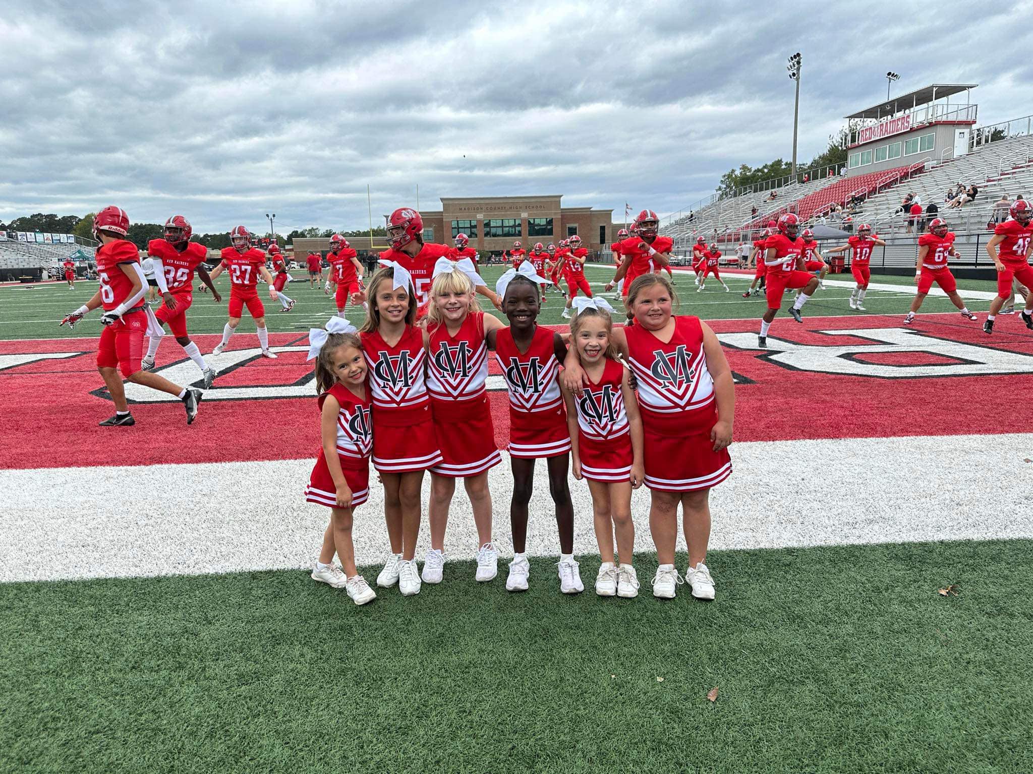 sideline_5 cheerleaders sitting